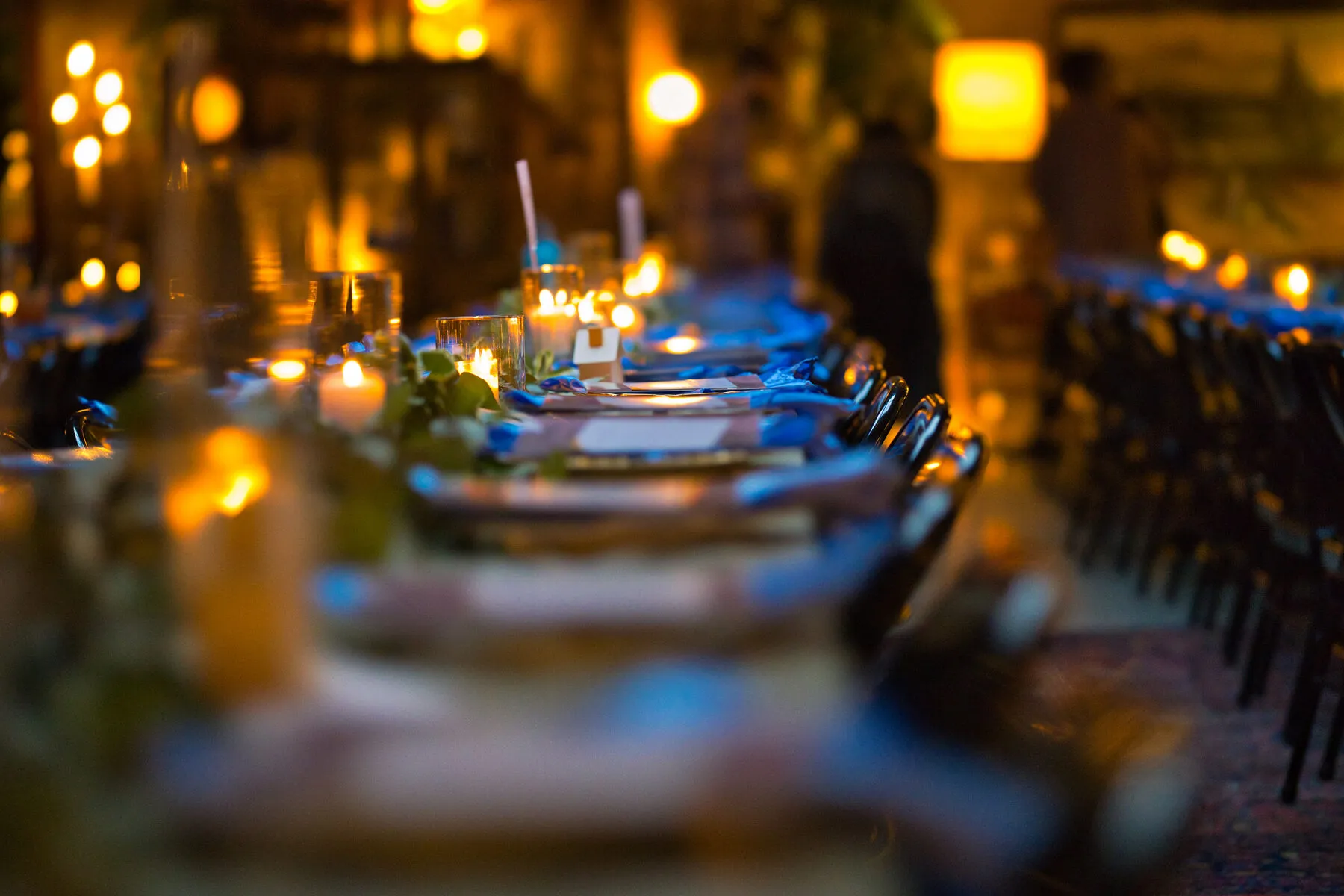 Candlelit tables set for a fundraiser dinner